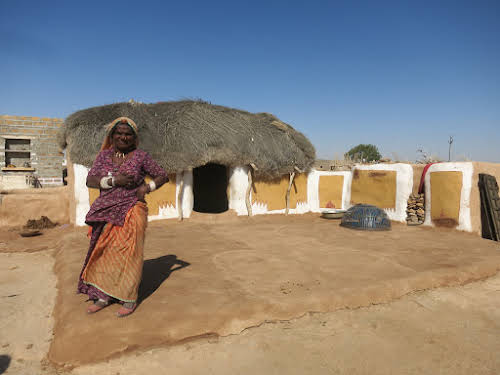 India. Rajasthan Thar Desert Camel Trek. Old lady by her summer house.