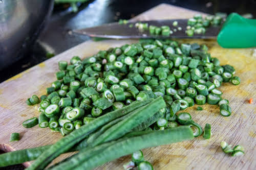 Indonesia. Bali Cooking Class. Slicing green beans for the Lawar Salad