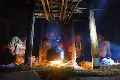 Indonesia. Papua Baliem Valley Trekking. Dinner time inside a traditional men's house in the Baliem Valley