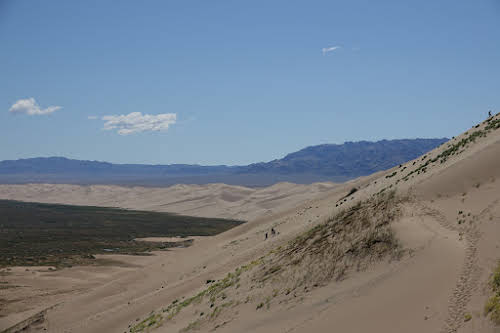 Tiny dark spots of people hiking up
