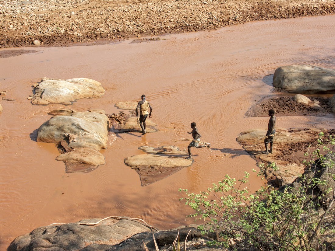 Hunters crossing the river